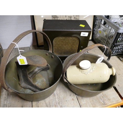 141 - Two brass jam pans, shoe last, stoneware hot water bottle and radio