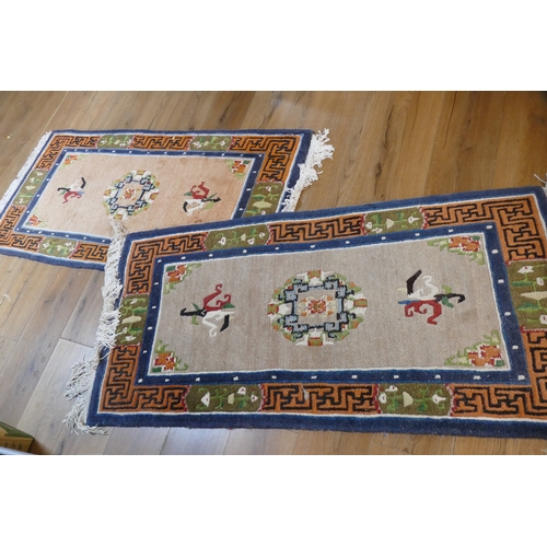 268 - Pair of rugs with geometric designs, +/- 140 cm x 73 cm