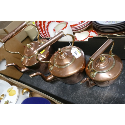 300 - Three graduated copper and brass kettles