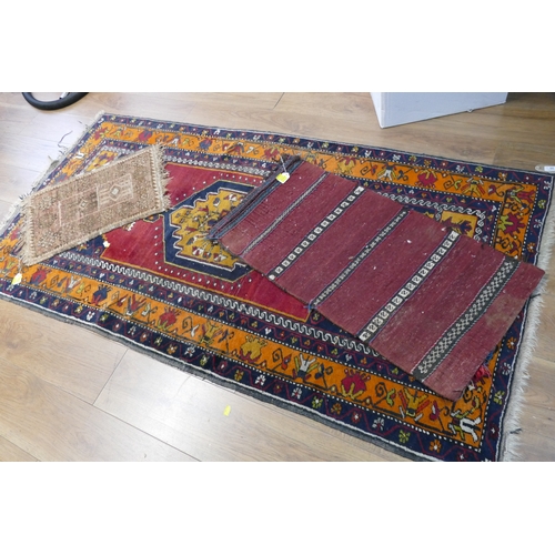 35 - Large patterned rug, 194 cm x 101 cm, and two smaller doormat size rugs