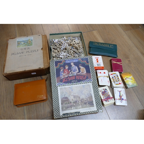 41 - Vintage jigsaw puzzles, travelling chess set, travelling Scrabble and playing cards etc including Th... 