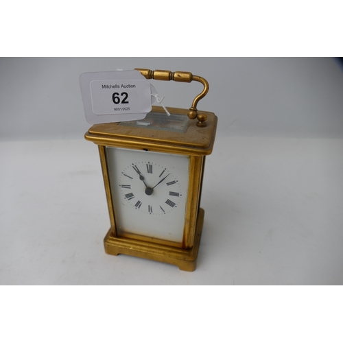 62 - Small brass carriage clock with French movement and key, height 14 cm