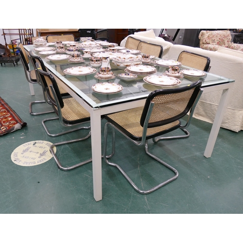 603 - Heavy glazed top modern table and eight bergere seated retro style chairs