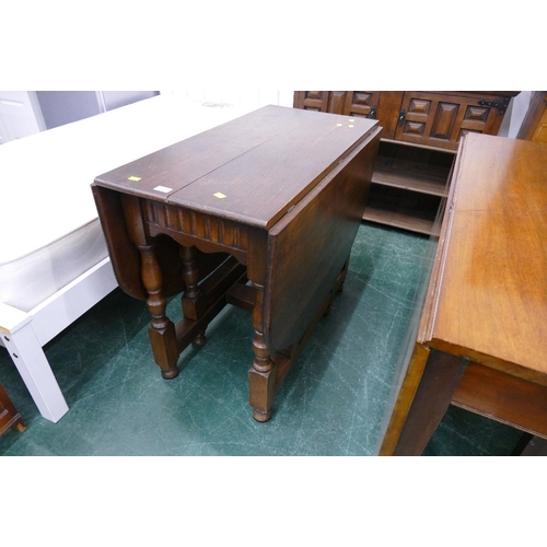 562 - Oak Priory style carved twin drop flap gate leg table