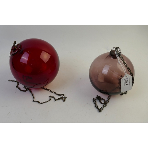 327 - Two red and purple glass Kugel balls, largest 15 cm diameter.