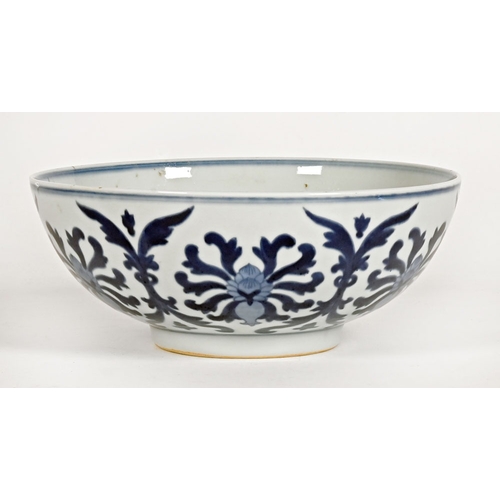 17 - A Chinese blue and white bowl, with repeating foliate and scroll decoration with six character mark ... 