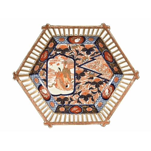 26 - An Imari hexagonal dish, with pierced basket style decoration, the interior decorated with two figur... 