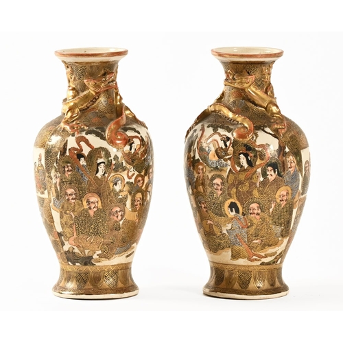 27 - A pair of Satsuma vases, decorated with dragons Samurai etc.  Height +/- 24 cm.