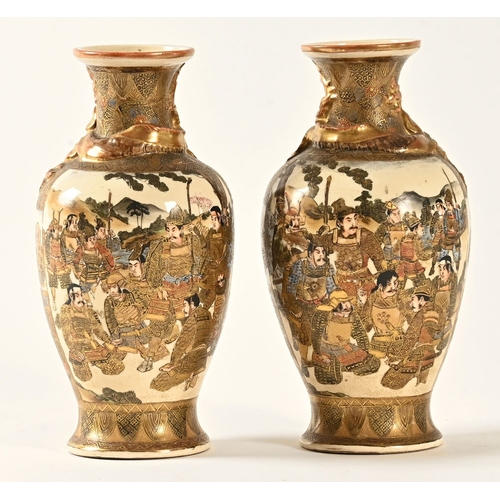 27 - A pair of Satsuma vases, decorated with dragons Samurai etc.  Height +/- 24 cm.