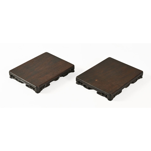 28 - A pair of Chinese low rectangular hardwood stands.  Height 2.5 cm, width 18 cm, depth 14 cm.