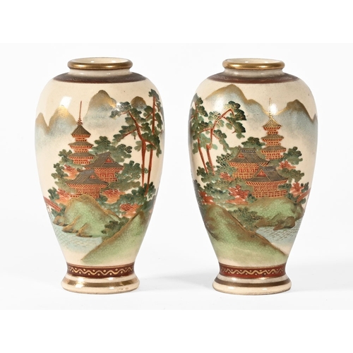 36 - A pair of Japanese vases, decorated with pagodas bridges etc.  Height 12 cm.