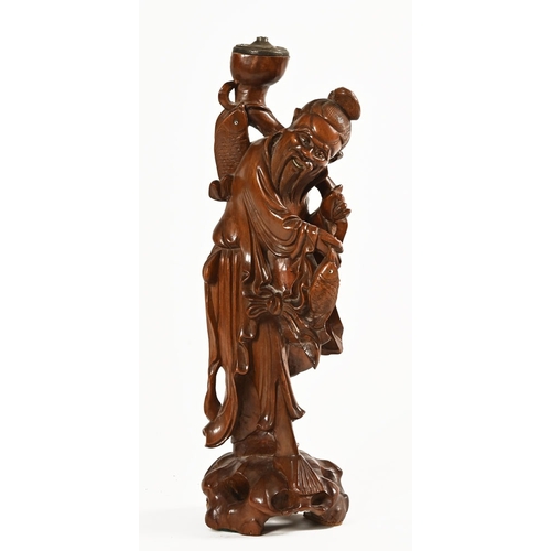 45 - A Chinese figure of a fisherman, hardwood with light fitting to top. Height 49 cm.