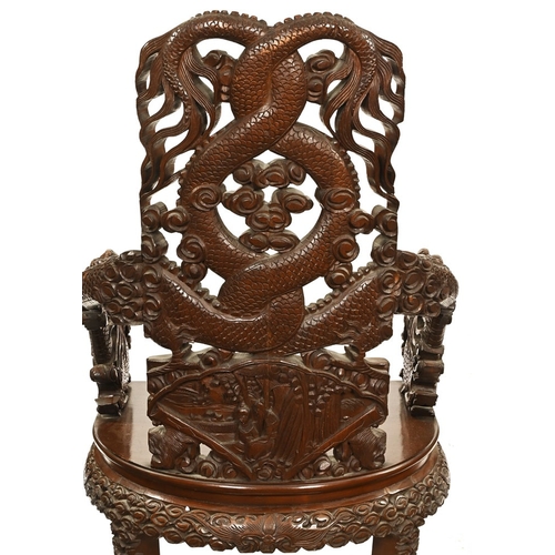 49 - An oriental carved armchair, the arms and back in the form of dragons.  Height 110 cm, width 62 cm, ... 