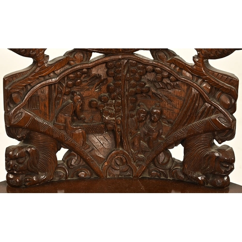 49 - An oriental carved armchair, the arms and back in the form of dragons.  Height 110 cm, width 62 cm, ... 