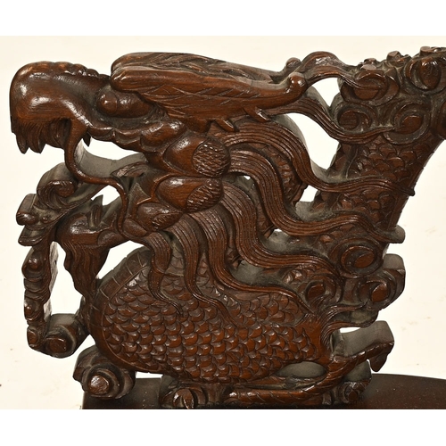 49 - An oriental carved armchair, the arms and back in the form of dragons.  Height 110 cm, width 62 cm, ... 