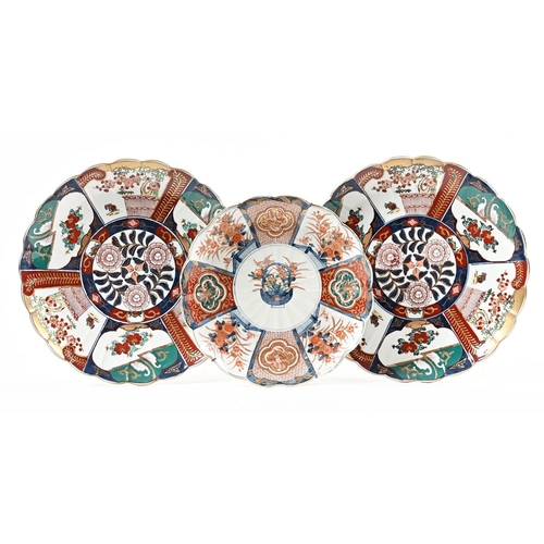 54 - A pair of Imari scalloped chargers.  Diameter 36 cm, together with another diameter 31 cm.