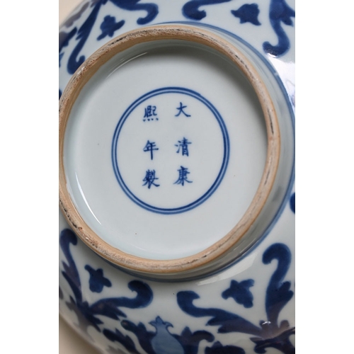 17 - A Chinese blue and white bowl, with repeating foliate and scroll decoration with six character mark ... 