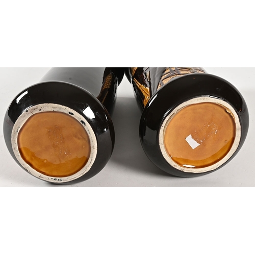 143 - A pair of Royal Doulton Series Ware style vases, decorated with Dickensian scenes, one marked to the... 