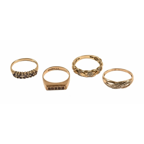 317 - Three 9 ct gold rings, and a yellow metal ring.  8.4 grams.