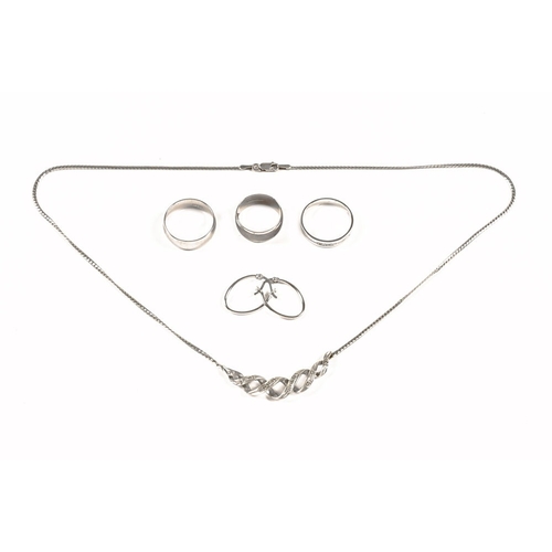 334 - A 9 ct white gold necklace, three 9 ct gold rings and 9 ct gold earrings.  17.3 grams.