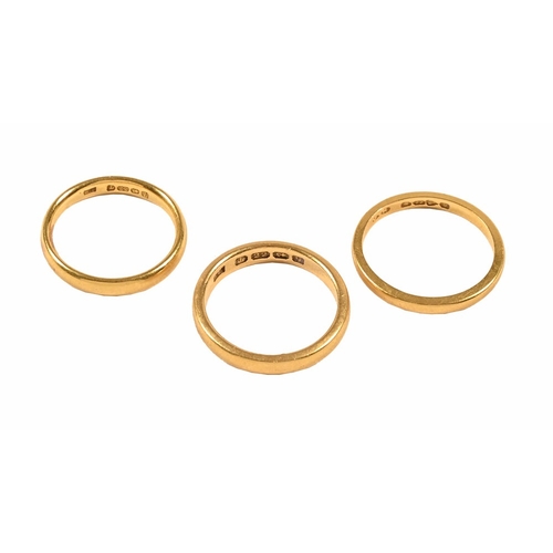 406 - Three 22 ct gold wedding bands. 12.1 grams.