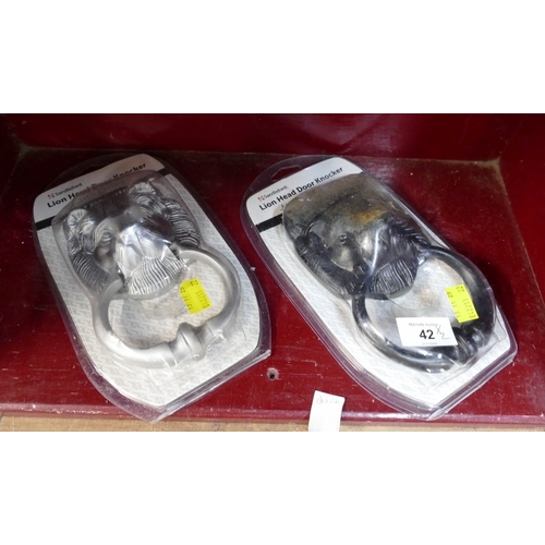 42 - Two Sandleford lion head door knockers, one black one chrome