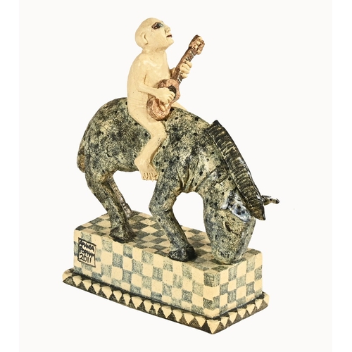 150 - Amanda Popham (born 1954), studio pottery figure of man on horseback with guitar, signed and dated 2... 
