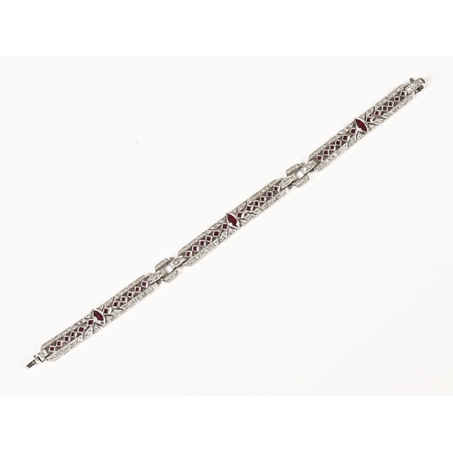 200 - An 18 ct white gold diamond and ruby bracelet. Length 18 cm, the large rubies measuring +/- 6 mm in ... 