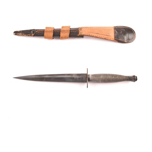 309 - An FS Fairbairn Sykes British Commando dagger, with ribbed metal hilt and crossguard, the double edg... 