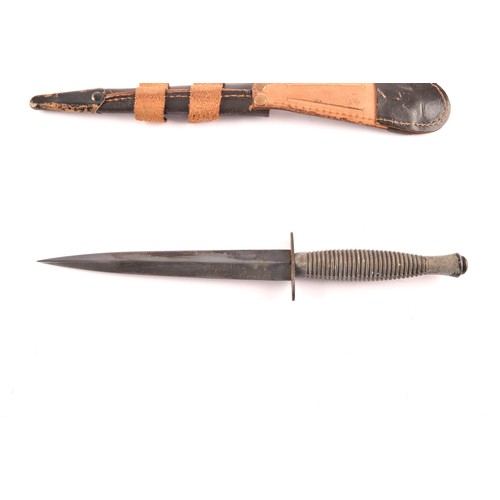 309 - An FS Fairbairn Sykes British Commando dagger, with ribbed metal hilt and crossguard, the double edg... 