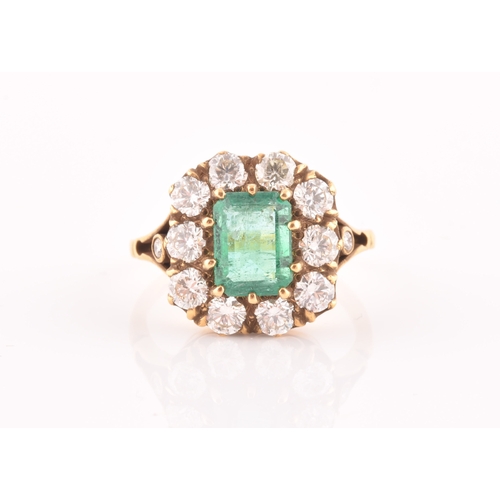 5 - An 18ct yellow gold, diamond, and emerald ring, centred with a mixed emerald-cut emerald of approxim... 