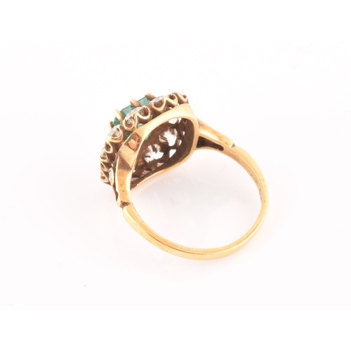 5 - An 18ct yellow gold, diamond, and emerald ring, centred with a mixed emerald-cut emerald of approxim... 