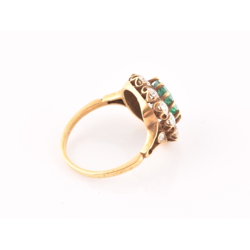 5 - An 18ct yellow gold, diamond, and emerald ring, centred with a mixed emerald-cut emerald of approxim... 