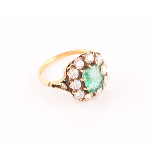 5 - An 18ct yellow gold, diamond, and emerald ring, centred with a mixed emerald-cut emerald of approxim... 