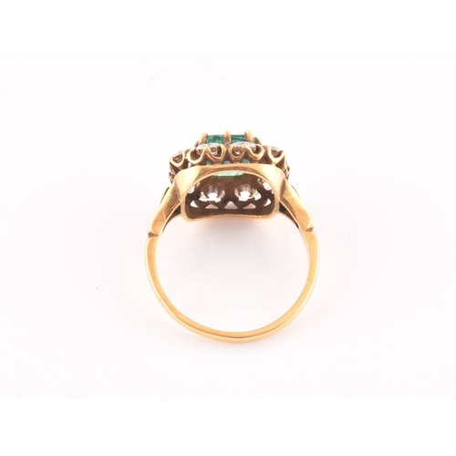 5 - An 18ct yellow gold, diamond, and emerald ring, centred with a mixed emerald-cut emerald of approxim... 