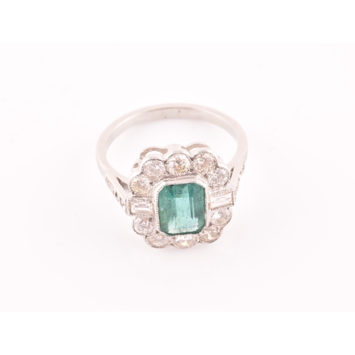 9 - A diamond and emerald cluster cocktail ring, set with an emerald-cut emerald of approximately 1.60 c... 