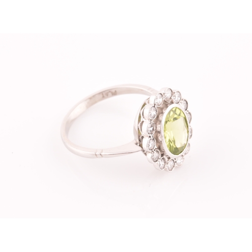 10 - A platinum, diamond, and peridot cluster ring, the mixed oval-cut peridot of approximately 1.60, wit... 