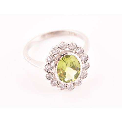 10 - A platinum, diamond, and peridot cluster ring, the mixed oval-cut peridot of approximately 1.60, wit... 