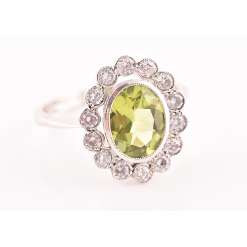 10 - A platinum, diamond, and peridot cluster ring, the mixed oval-cut peridot of approximately 1.60, wit... 