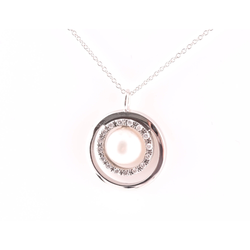 11 - A diamond and pearl halo pendant, centred with a cultured white pearl, measuring approximately 8.1 m... 