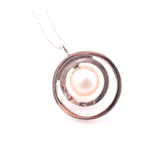 11 - A diamond and pearl halo pendant, centred with a cultured white pearl, measuring approximately 8.1 m... 