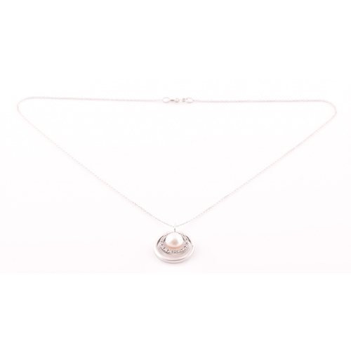 11 - A diamond and pearl halo pendant, centred with a cultured white pearl, measuring approximately 8.1 m... 