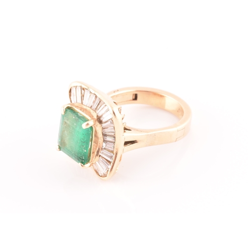 13 - An 18ct yellow gold, diamond, and emerald 'ballerina' cocktail ring, the waved mount inset with tape... 