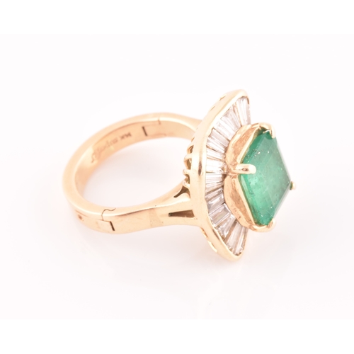 13 - An 18ct yellow gold, diamond, and emerald 'ballerina' cocktail ring, the waved mount inset with tape... 