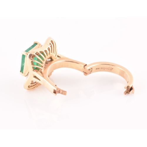 13 - An 18ct yellow gold, diamond, and emerald 'ballerina' cocktail ring, the waved mount inset with tape... 