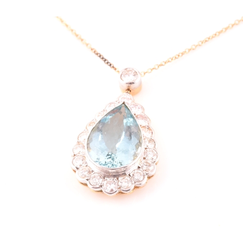 14 - An 18ct yellow gold, diamond, and aquamarine pendant, set with a mixed pear-cut aquamarine of approx... 