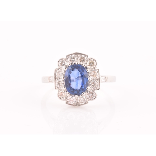 17 - A platinum, diamond, and sapphire ring, centred with a mixed oval-cut sapphire of approximately 1.65... 