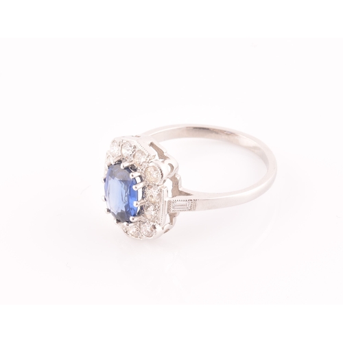 17 - A platinum, diamond, and sapphire ring, centred with a mixed oval-cut sapphire of approximately 1.65... 