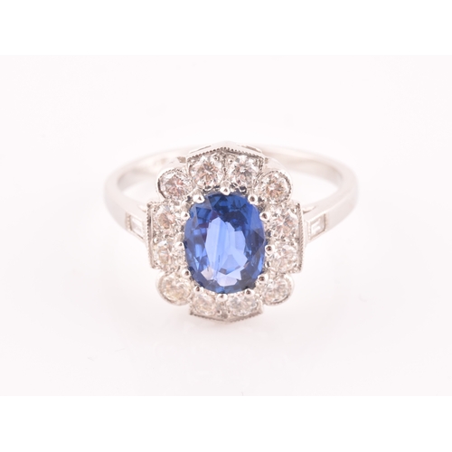 17 - A platinum, diamond, and sapphire ring, centred with a mixed oval-cut sapphire of approximately 1.65... 