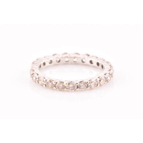 19 - A diamond eternity ring, set with twenty two round brilliant-cut diamonds, of approximately 1.0 cara... 